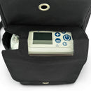 Black carry bag holding an Inogen portable oxygen concentrator with control panel visible