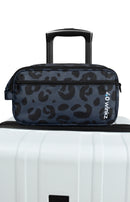 Blue and black leopard print travel bag on white suitcase with telescopic handle