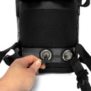 Hand connecting oxygen tubing to black mesh Inogen One G3 carry bag with metal grommets