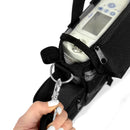 Hand attaching a portable oxygen concentrator bag, zipper pocket, keyring clasp, device visible