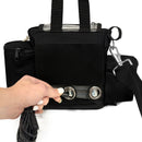 Hand connecting power cord to black portable oxygen concentrator carry bag with mesh panel