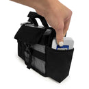 Hand placing battery in black Inogen One G3 carry bag with front pocket and handle