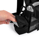 Hand placing accessory into side pocket of black oxygen concentrator backpack