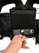 Hand plugs cable into black mesh Inogen One G3 or G4 oxygen backpack bag