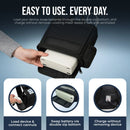 Hand loading portable oxygen concentrator into black carry bag with double-zip bottom access.