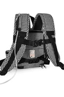 Black and white houndstooth oxygen concentrator backpack with adjustable straps and tubing.