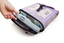 Hand placing portable oxygen concentrator in purple mesh carry bag