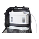 Inogen One portable oxygen concentrator inside a black mesh carry backpack with nasal cannula.