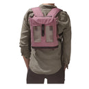 Person wearing a pink Inogen One G3 backpack oxygen concentrator carrier